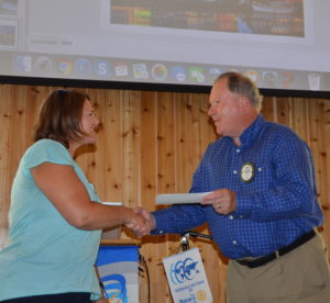 Spike present a NRF check to Michelle Bechtold for the Rotary Student Exchange Program partnership 081716